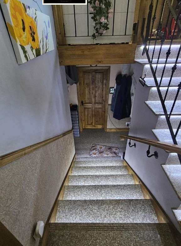 Narrow staircase with wooden door below