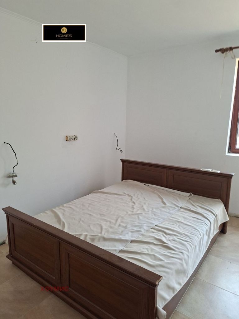 Minimalist bedroom with dark wooden bed frame