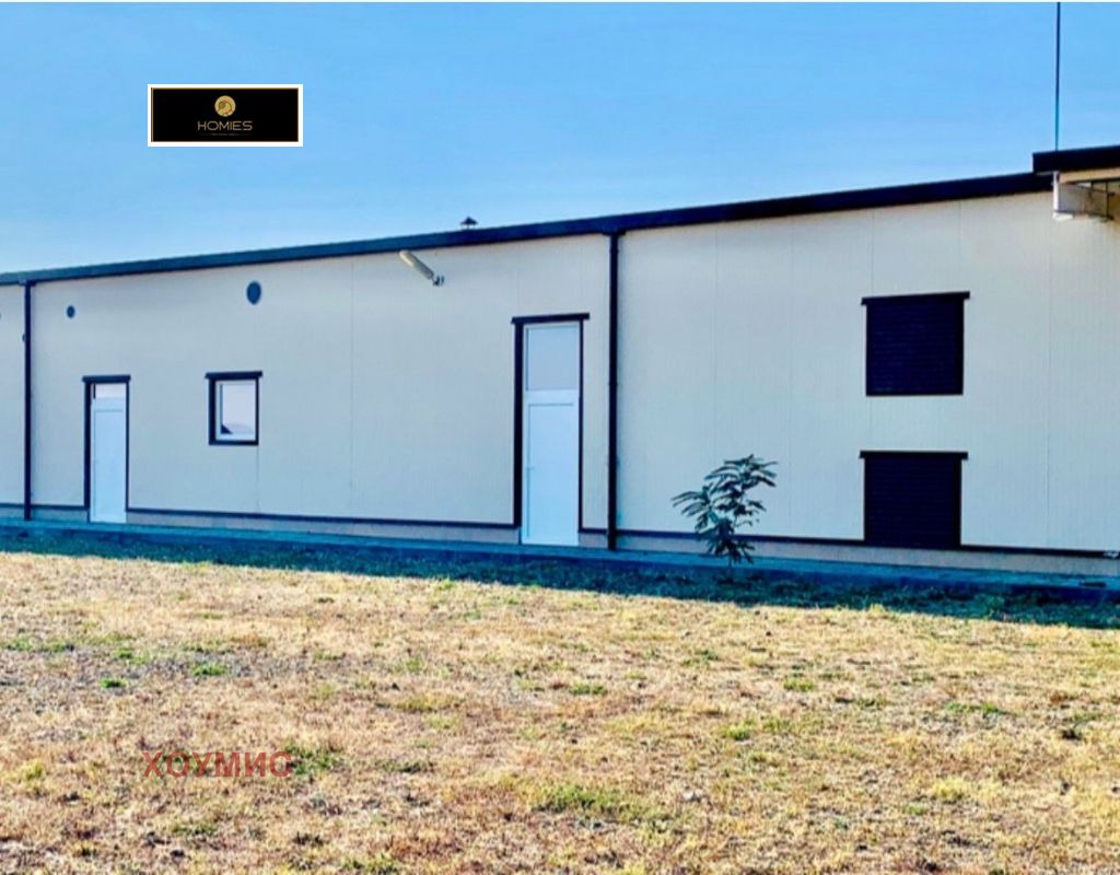 Industrial building exterior with blue trim and windows