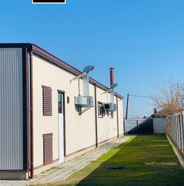 Cream colored industrial facility with burgundy accents outside