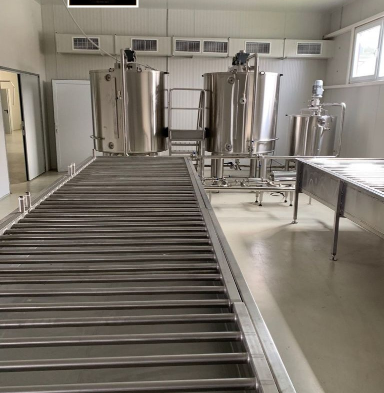 Stainless steel fermentation tanks in commercial honey production facility