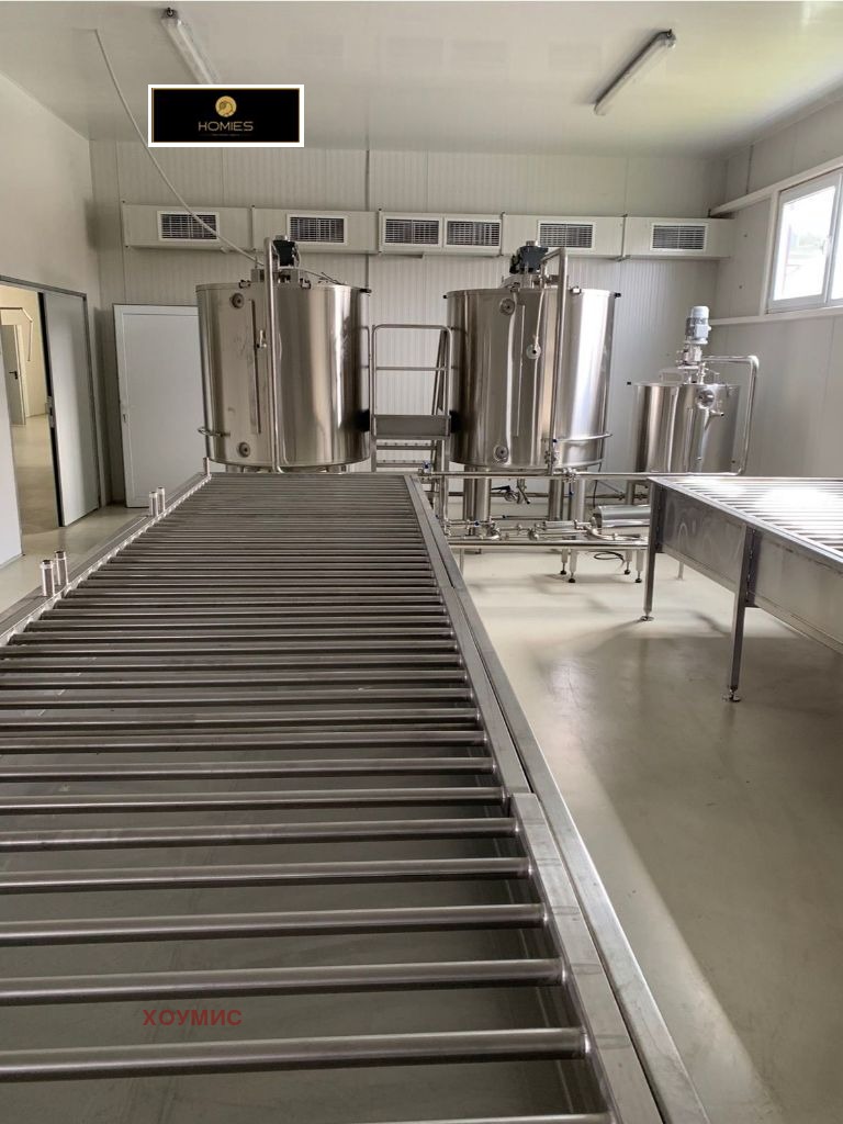 Stainless steel fermentation tanks in commercial honey production facility