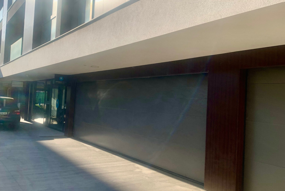 Closed garage with brown roller door entrance