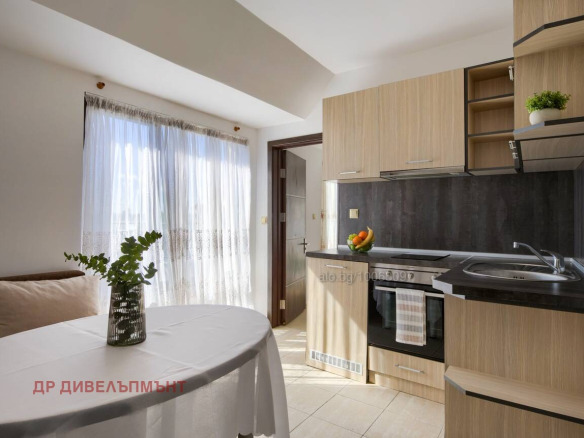 Modern kitchen with living area and bright terrace