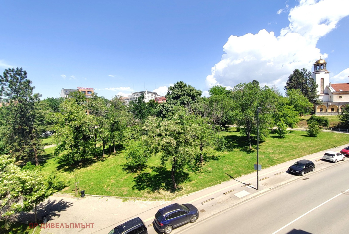 Panoramic view of green park and church