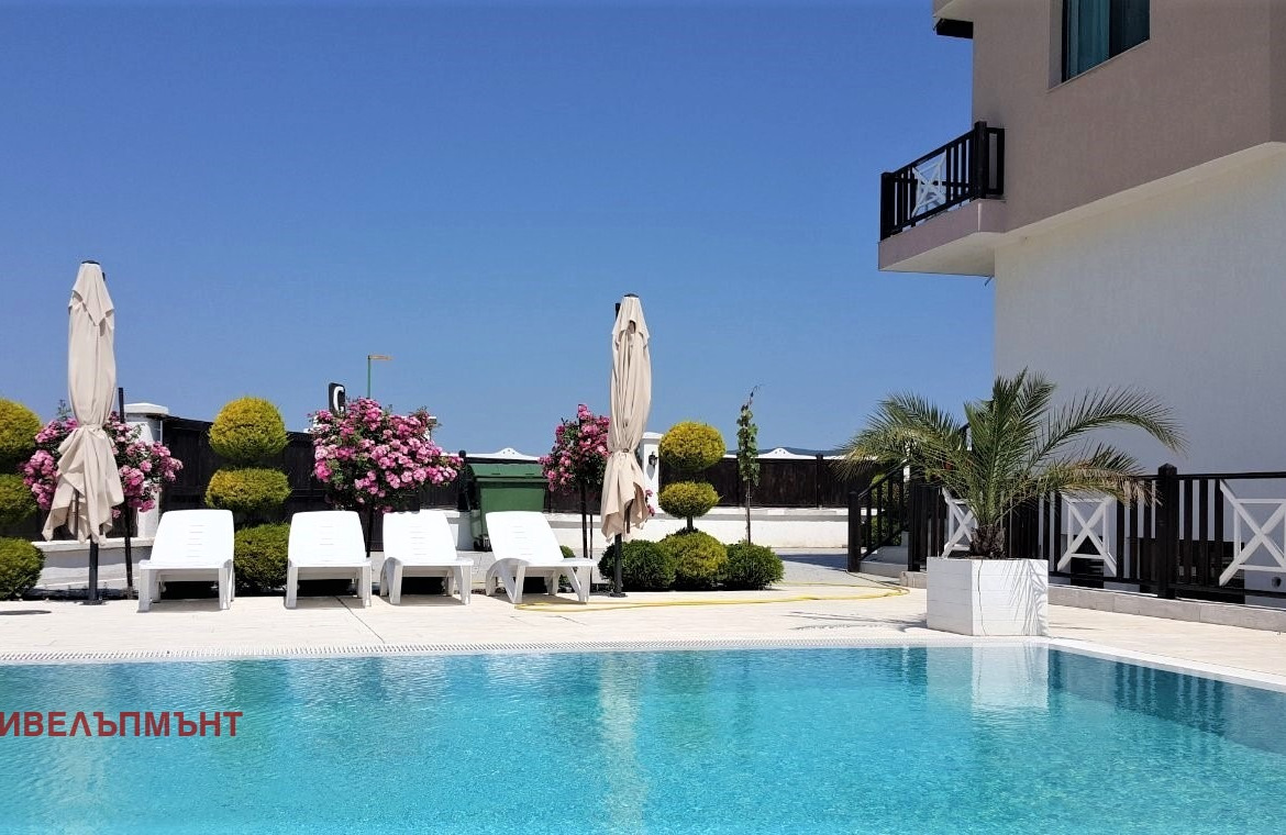 Luxury pool with loungers and white umbrellas
