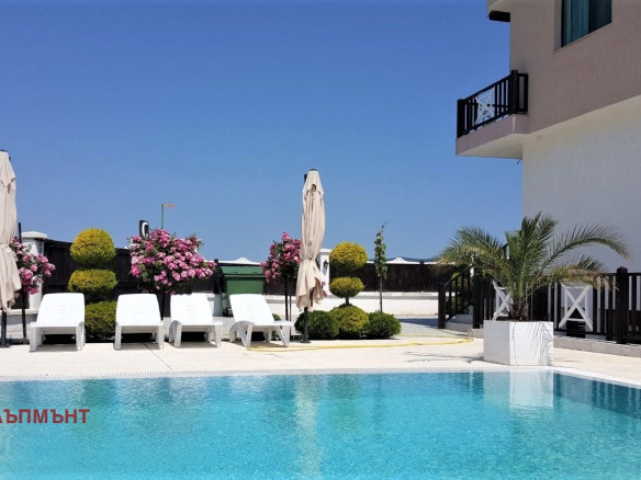 Luxury pool with loungers and white umbrellas