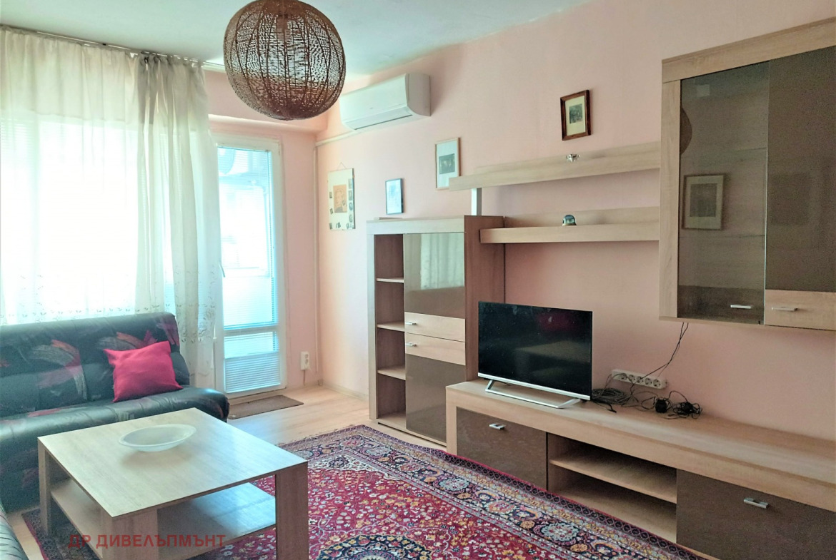 Bright living room with pink walls and modern furniture