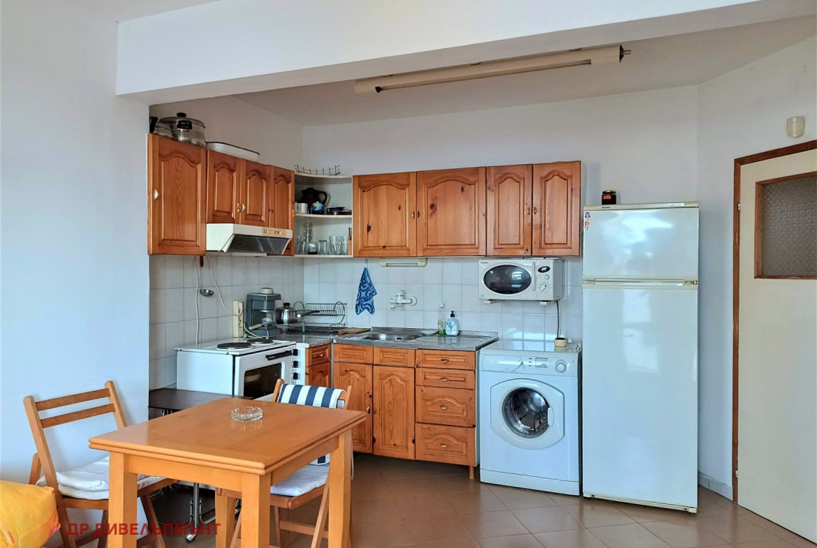 Kitchen with wooden cabinets and white refrigerator