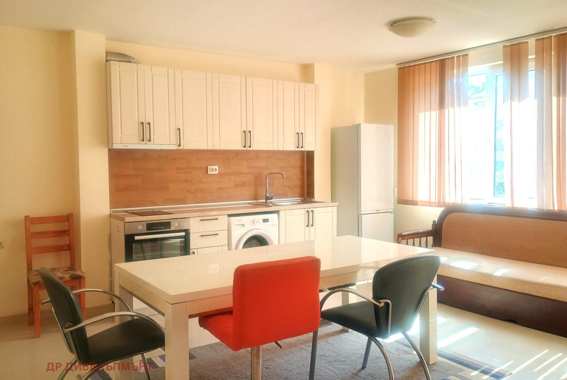 Modern kitchen with white cabinets and wooden backsplash