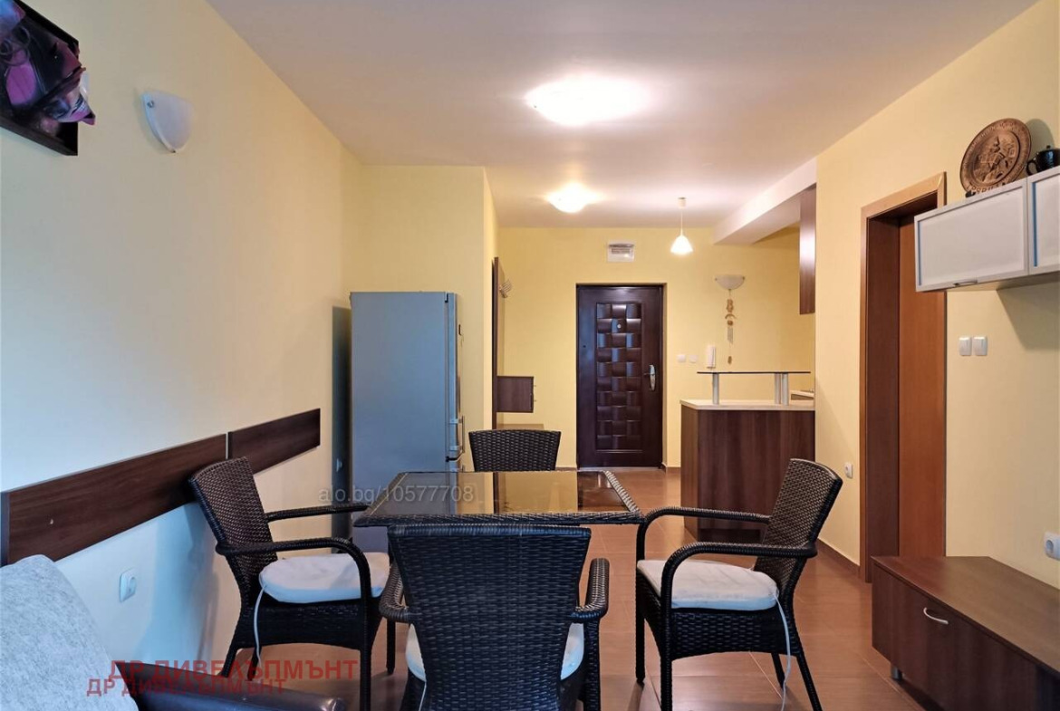 Bright living room with yellow walls and dark furniture