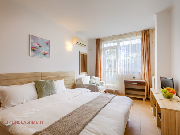 Comfortable bedroom with wooden bed and balcony