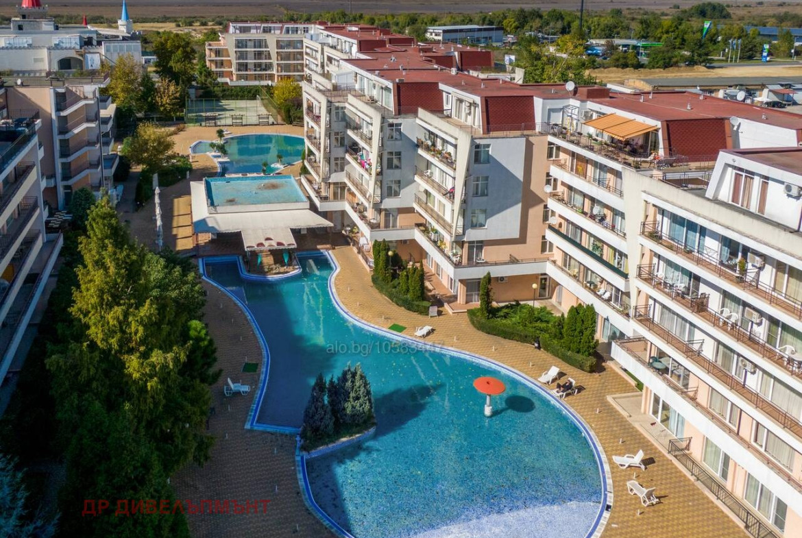 Aerial view of resort complex with pools and buildings