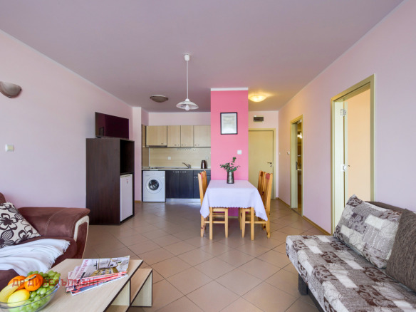 Spacious living room with pink walls and furniture