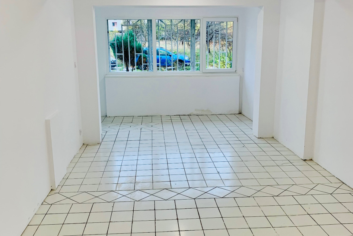 Empty shop with light tiles and large windows