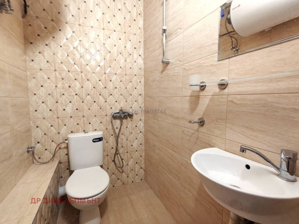Modern bathroom with beige tiles and shower cabin