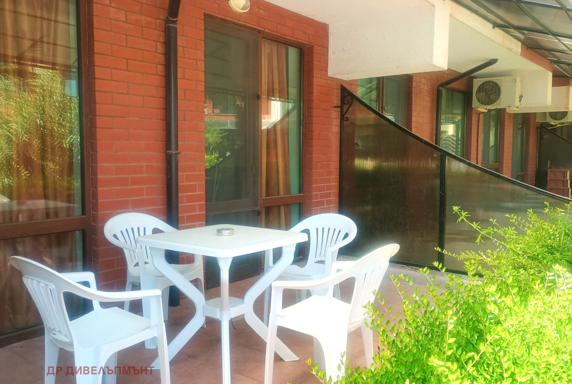 Terrace with white chairs and table