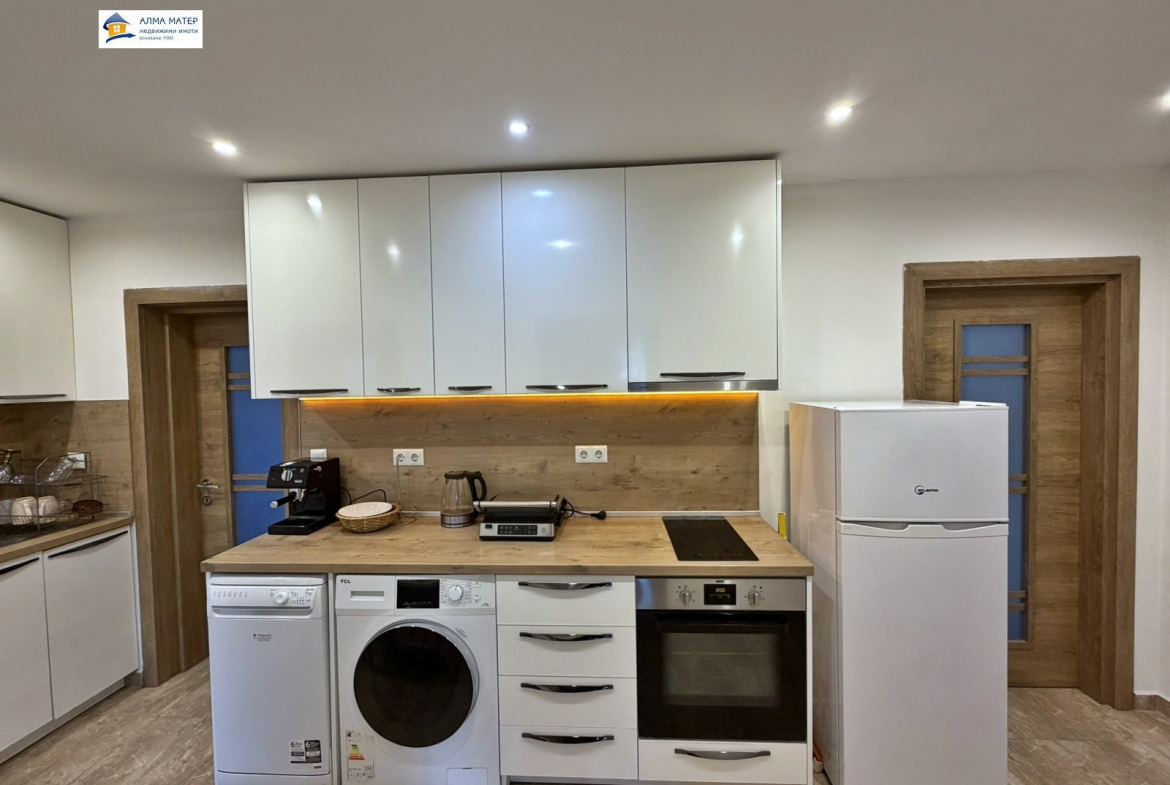 Modern kitchen with white cabinets and wood countertop