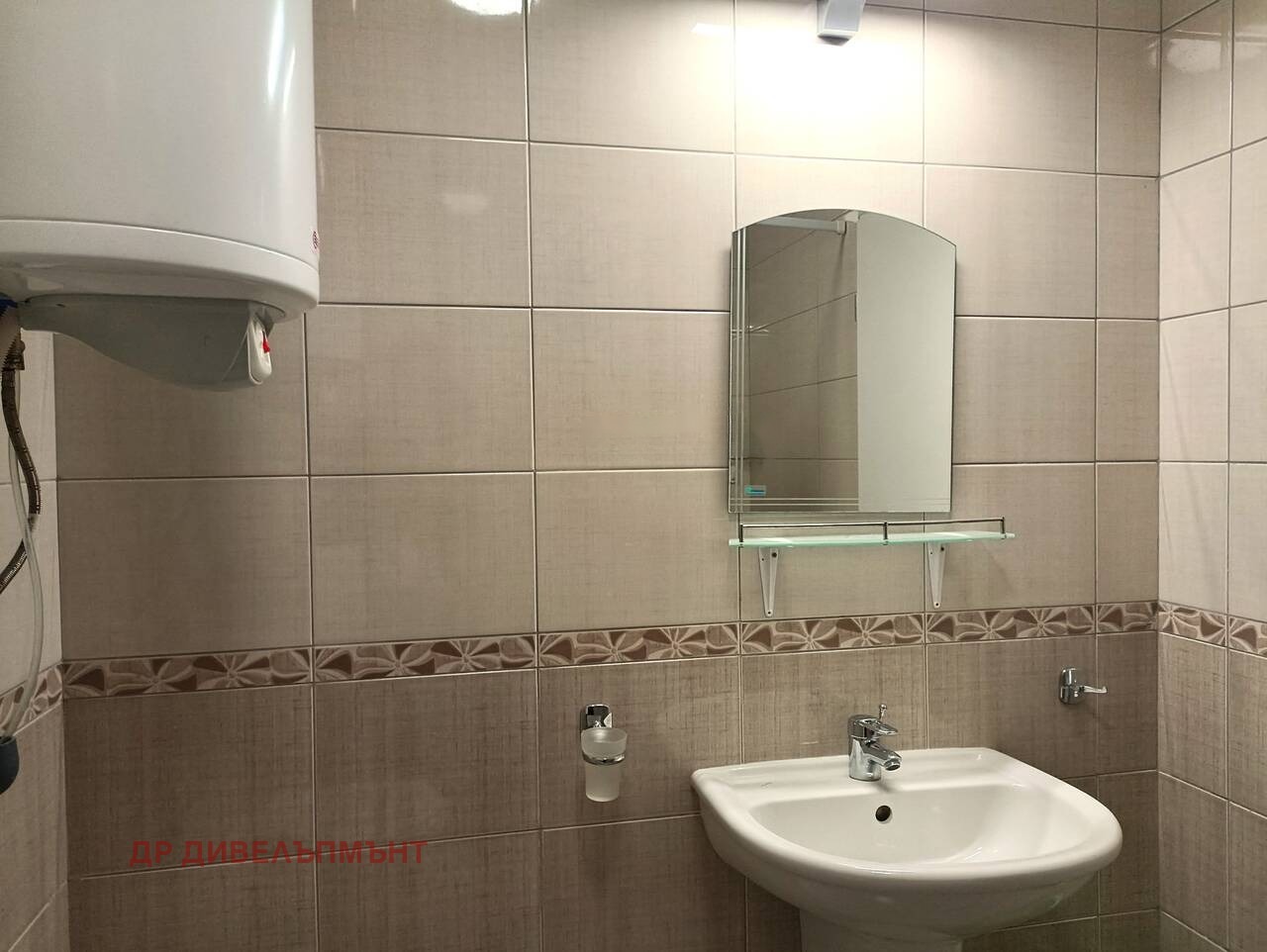 Compact bathroom with water heater sink and wall mirror