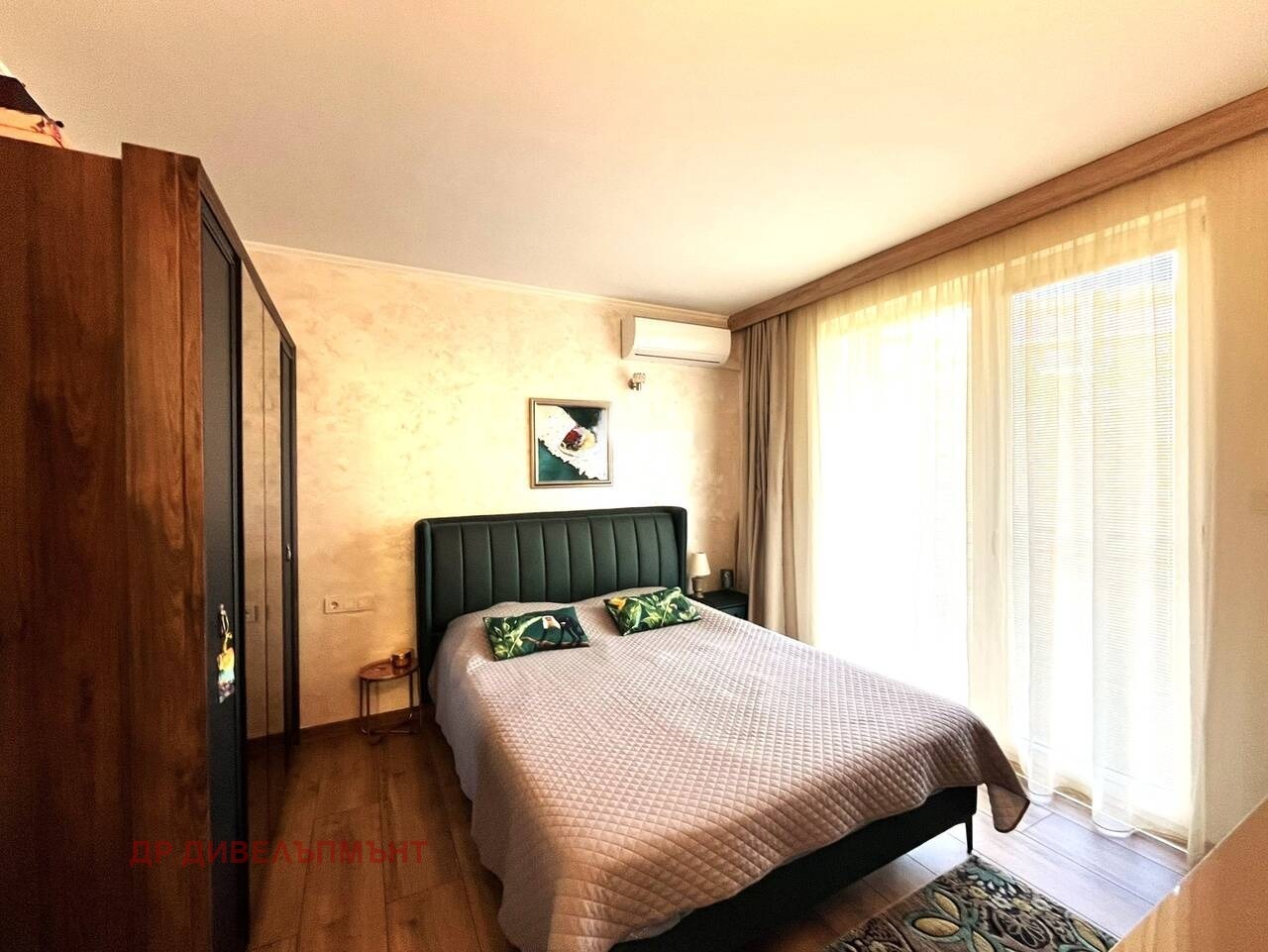 Bedroom with green headboard double bed balcony sliding door