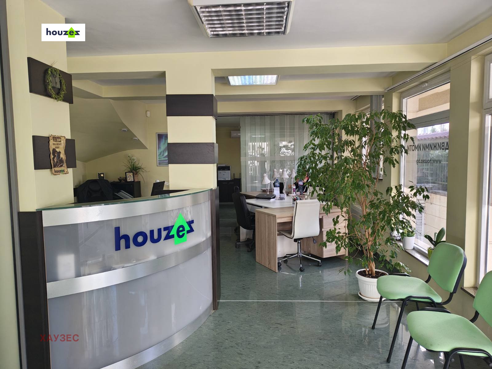Рецепция с кръгъл плот и логото Houzex