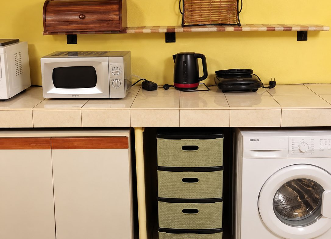 Kitchen with yellow walls and white appliances