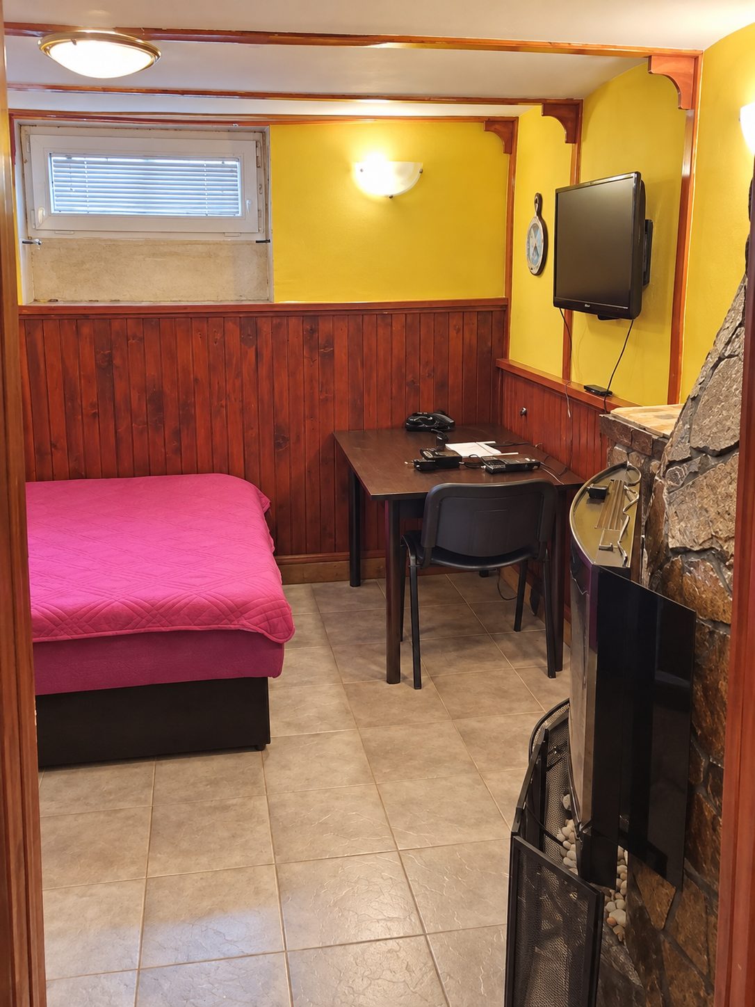 Bedroom with pink bed and television