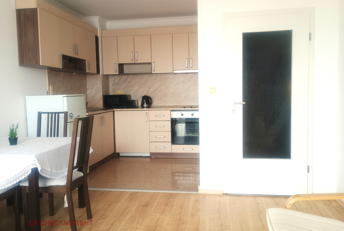 Modern kitchen with beige cabinets and appliances