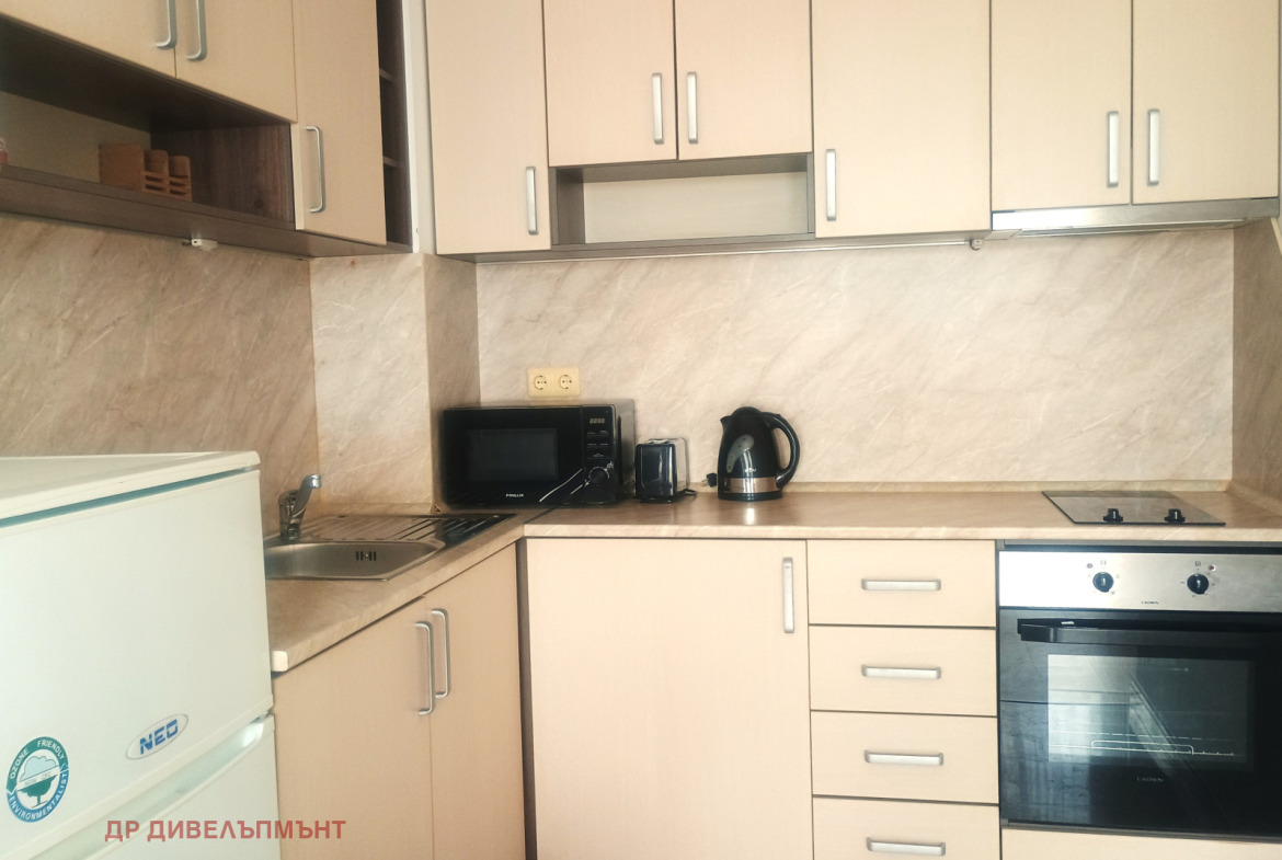 dvustaen-apartament-71-sqm-pod-naem-nesebar-kristal-biych-3 Kitchen counter detail with microwave and kettle