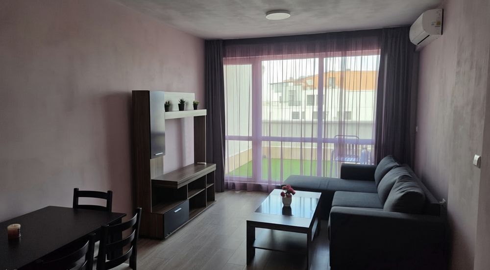 Living room with sofa, TV cabinet and panoramic window view