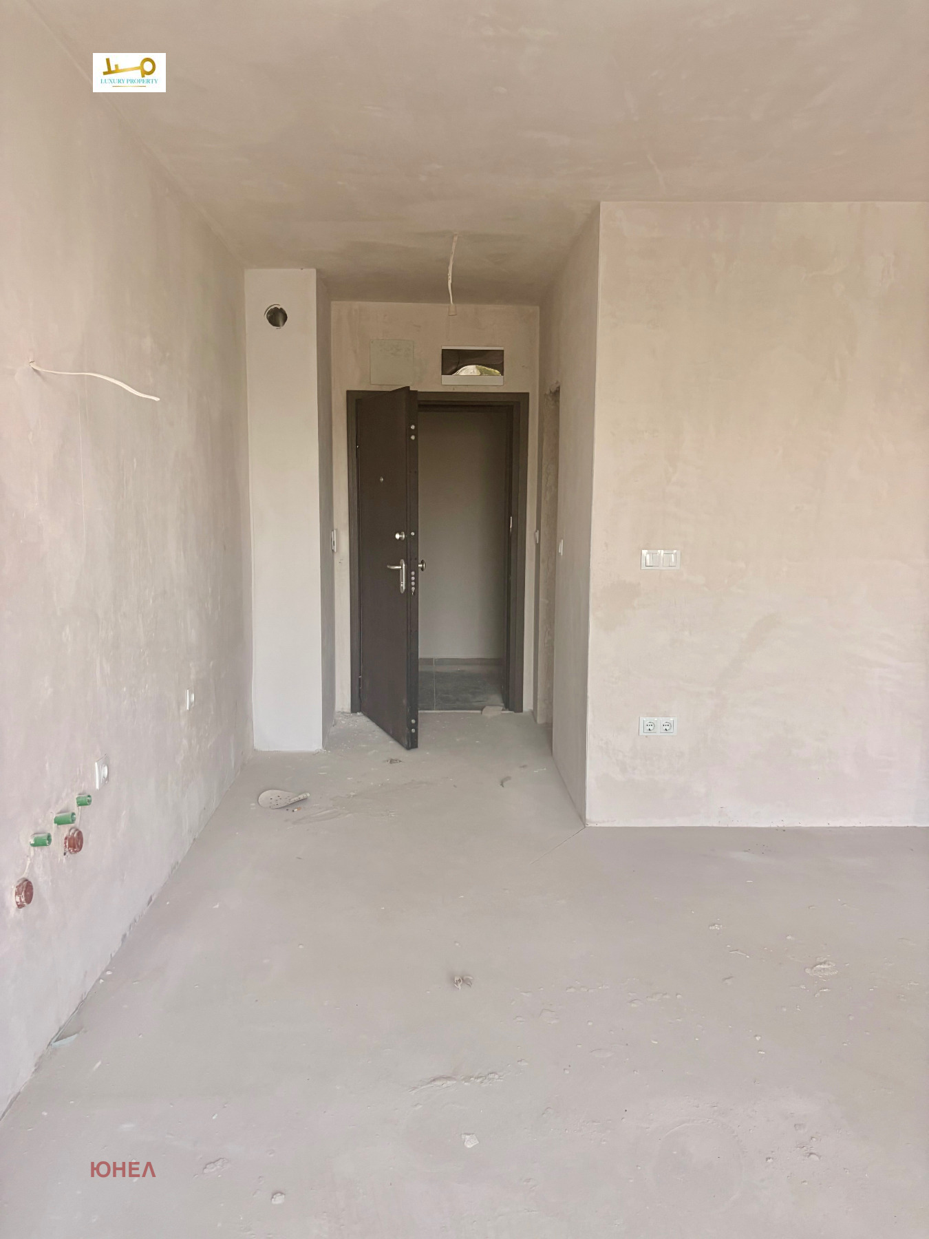 Apartment entrance corridor with door and wiring