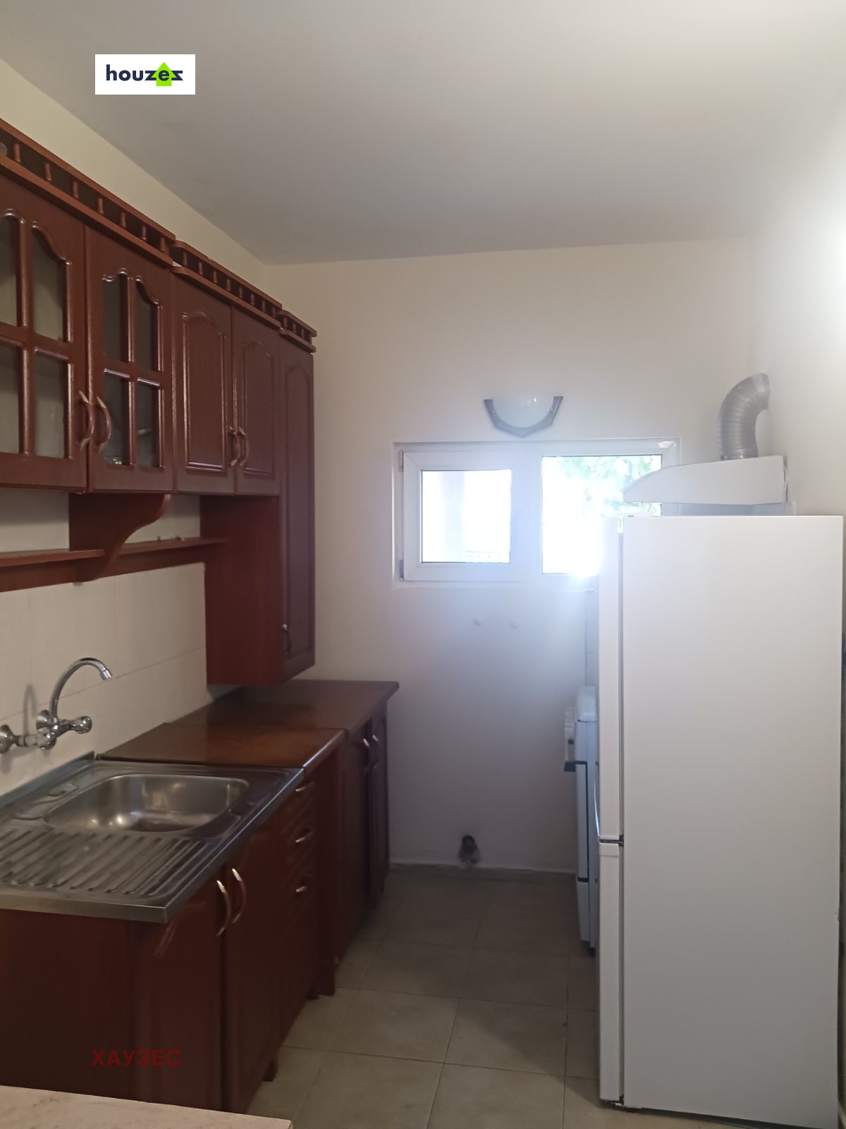 Modern kitchen with red cabinets and refrigerator