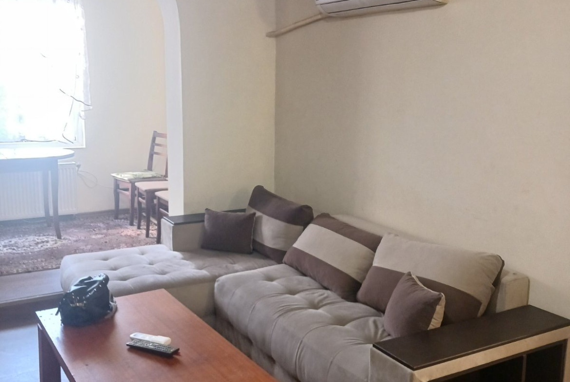 Living area with sofa and mounted air conditioner