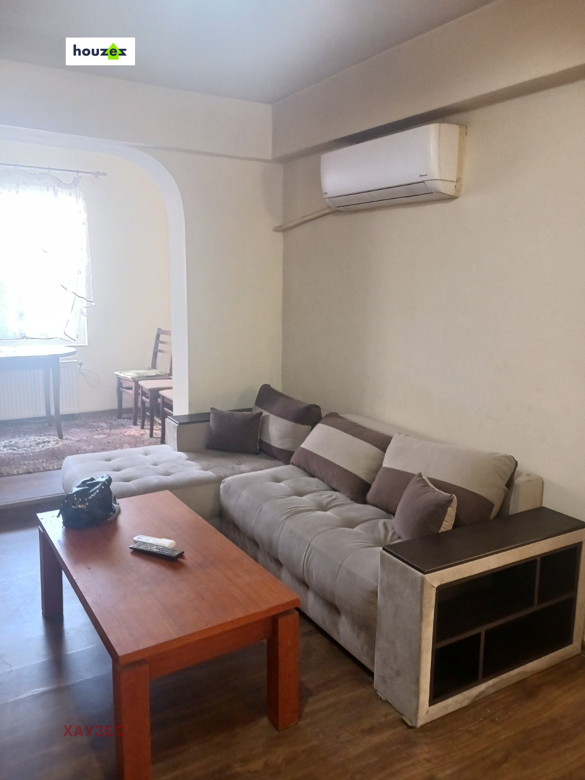 Living area with sofa and mounted air conditioner