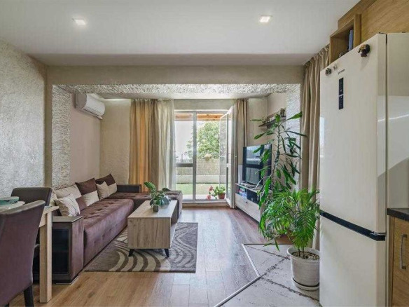 Просторен хол с кафяв диван и озеленение