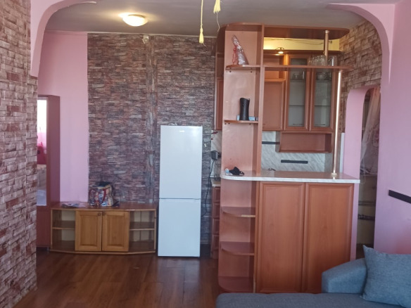 Spacious living room with pink walls and furniture