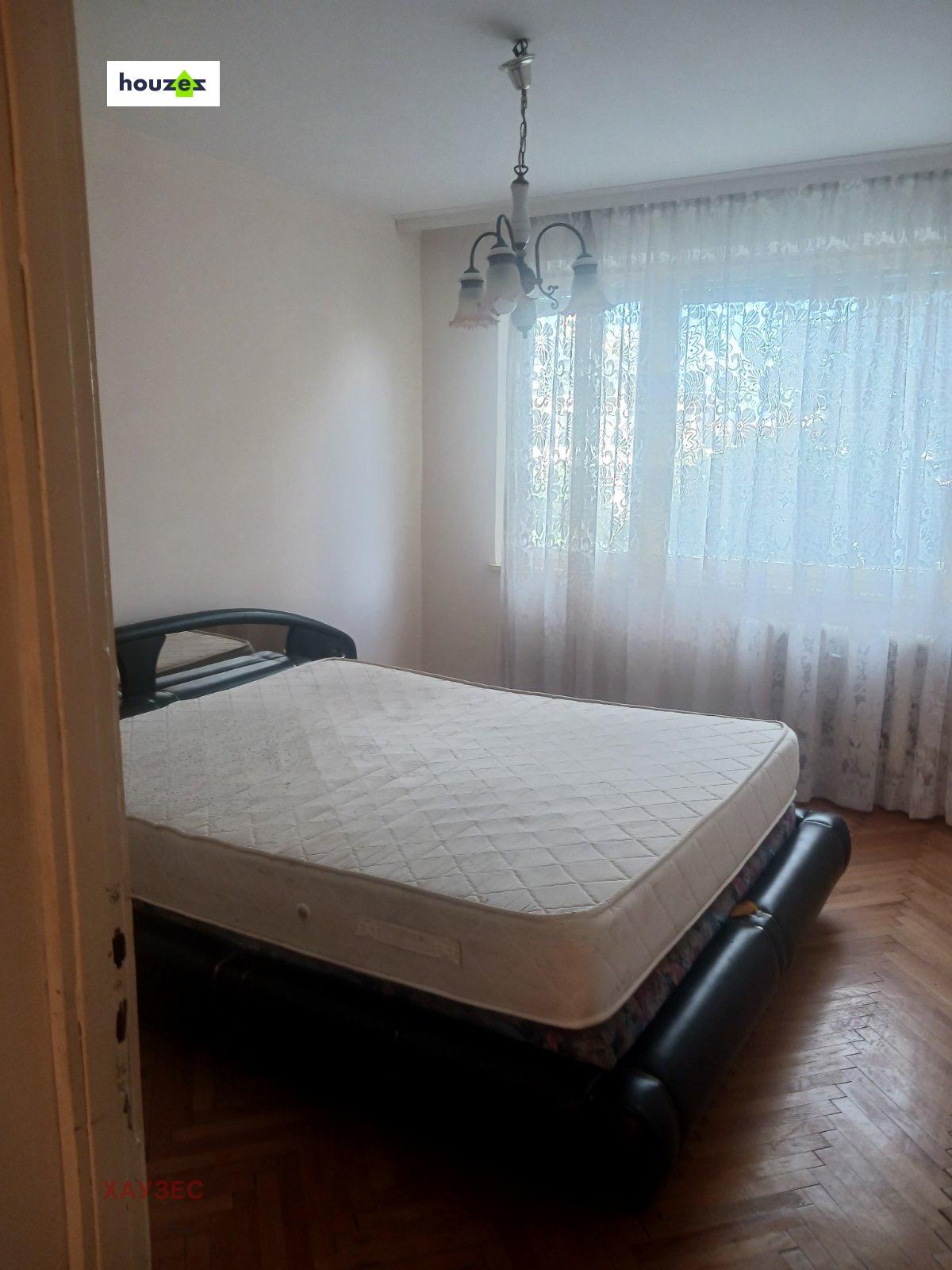 tristaen-apartament-90-sqm-pod-naem-lyulin-3-sofia-obzaveden-sklad-10 Спалня с двойно легло без спално бельо, паркетен под и прозорец с тюлена завеса