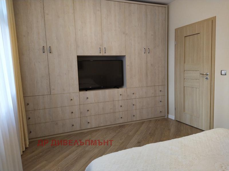 Master bedroom with comfortable bed and bedside tables
