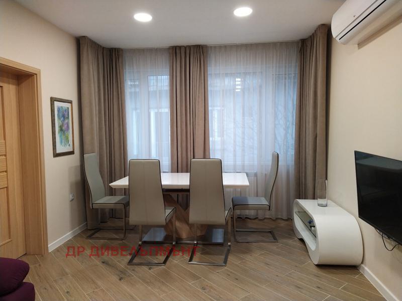 Modern dining area with white chairs and windows