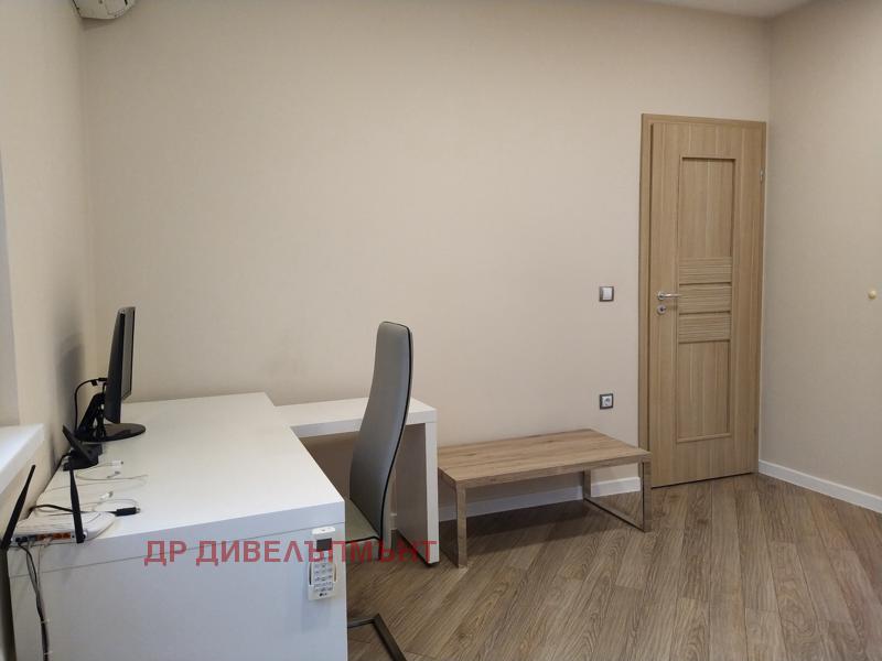 Bright bedroom with double bed and television