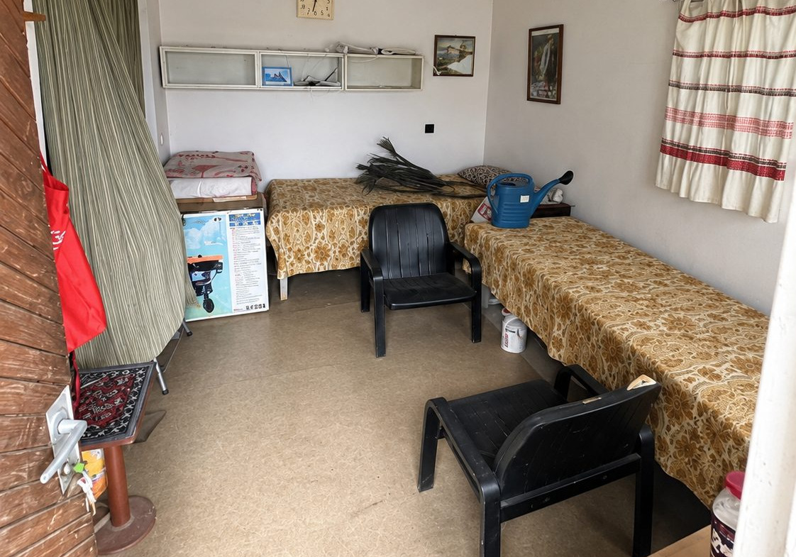 Interior room with beds and black plastic chairs