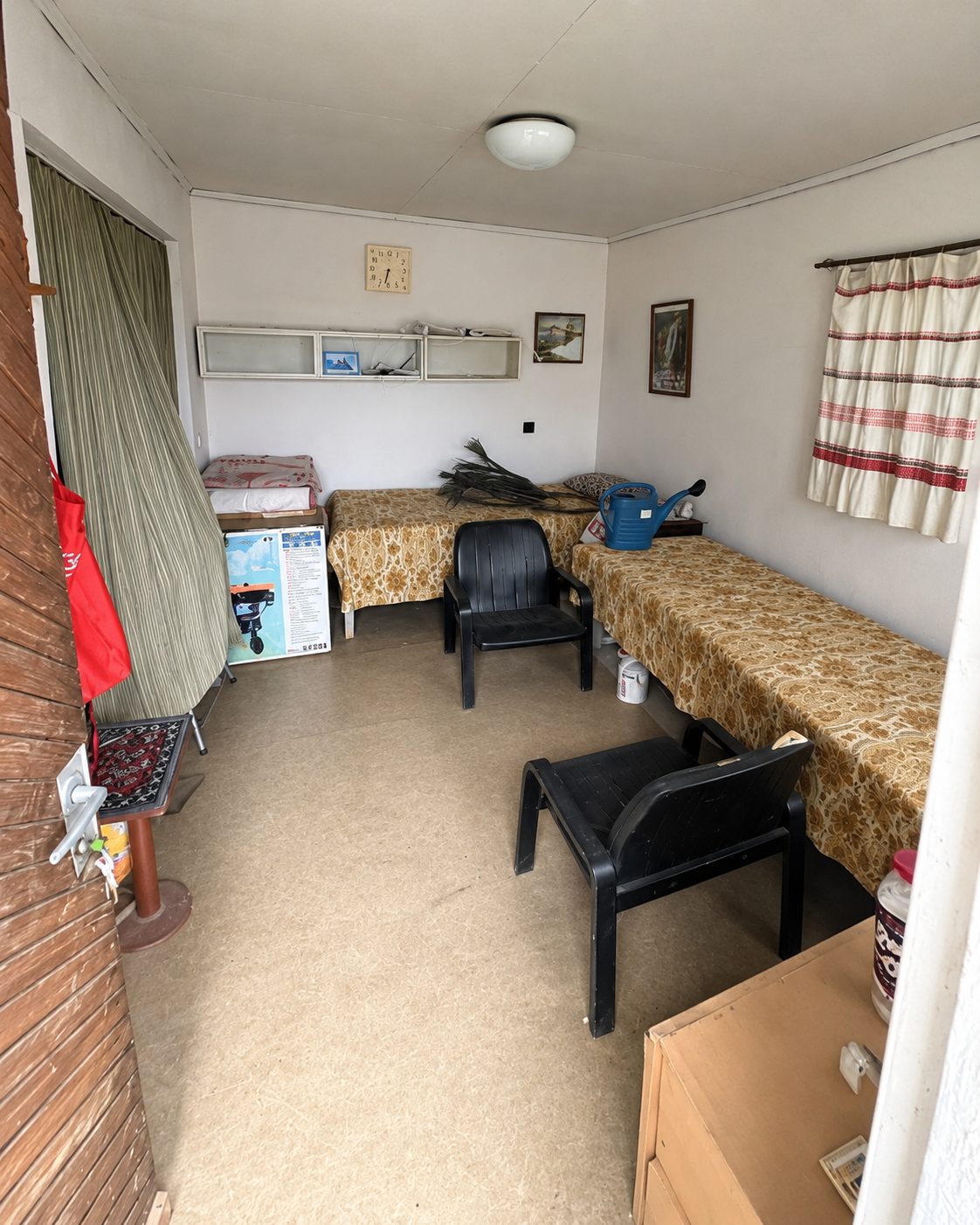 Interior room with beds and black plastic chairs