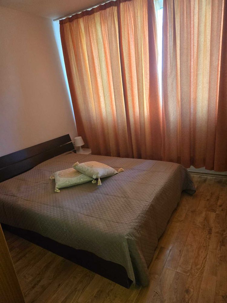 dvustaen-apartament-52-kvm-pod-naem-mladost-2-otdelen-vhod-13 Спалня с двойно легло, тъмно табло и оранжеви завеси на прозореца