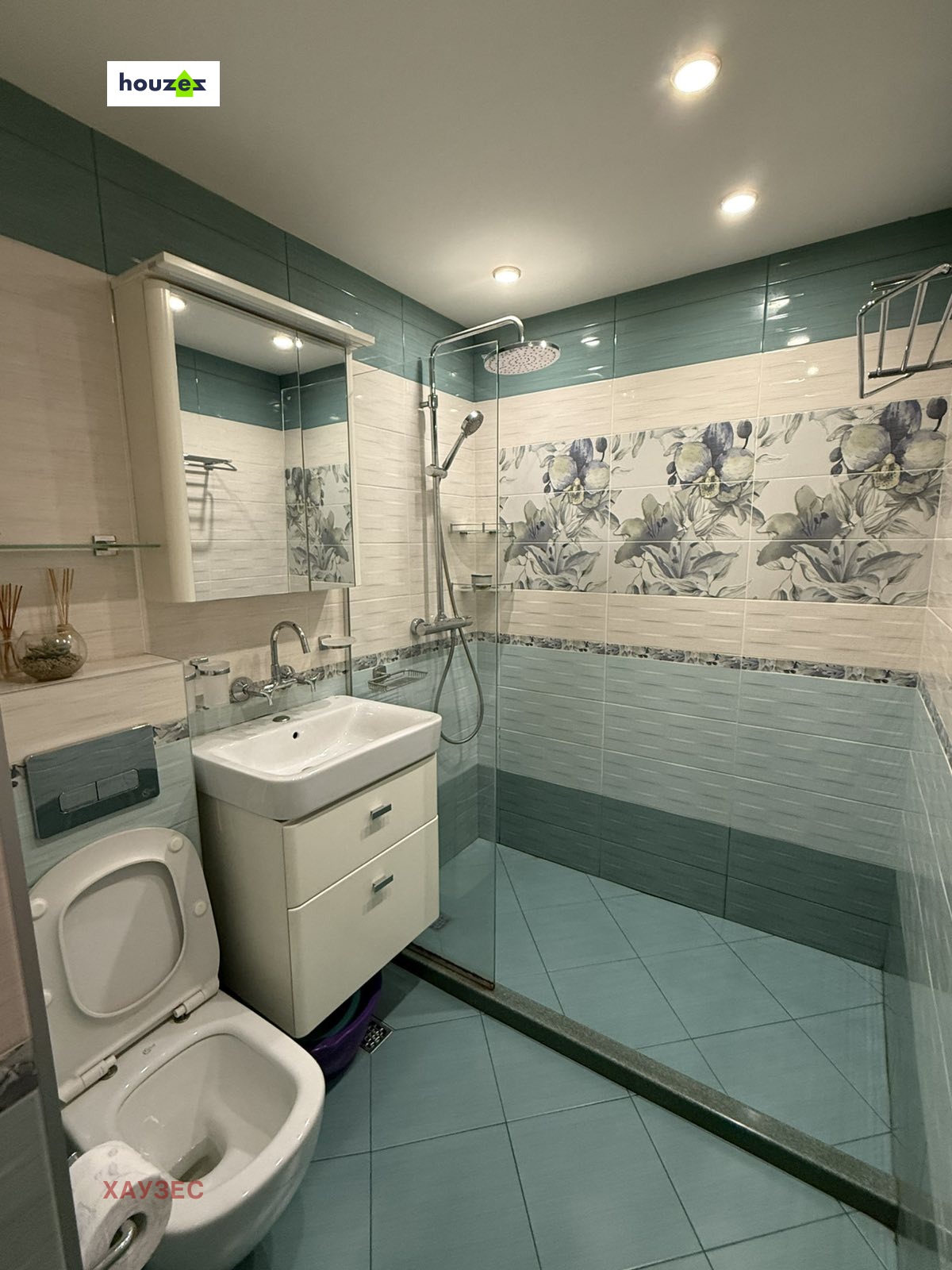 Bathroom with shower, toilet, vanity unit, teal tiles
