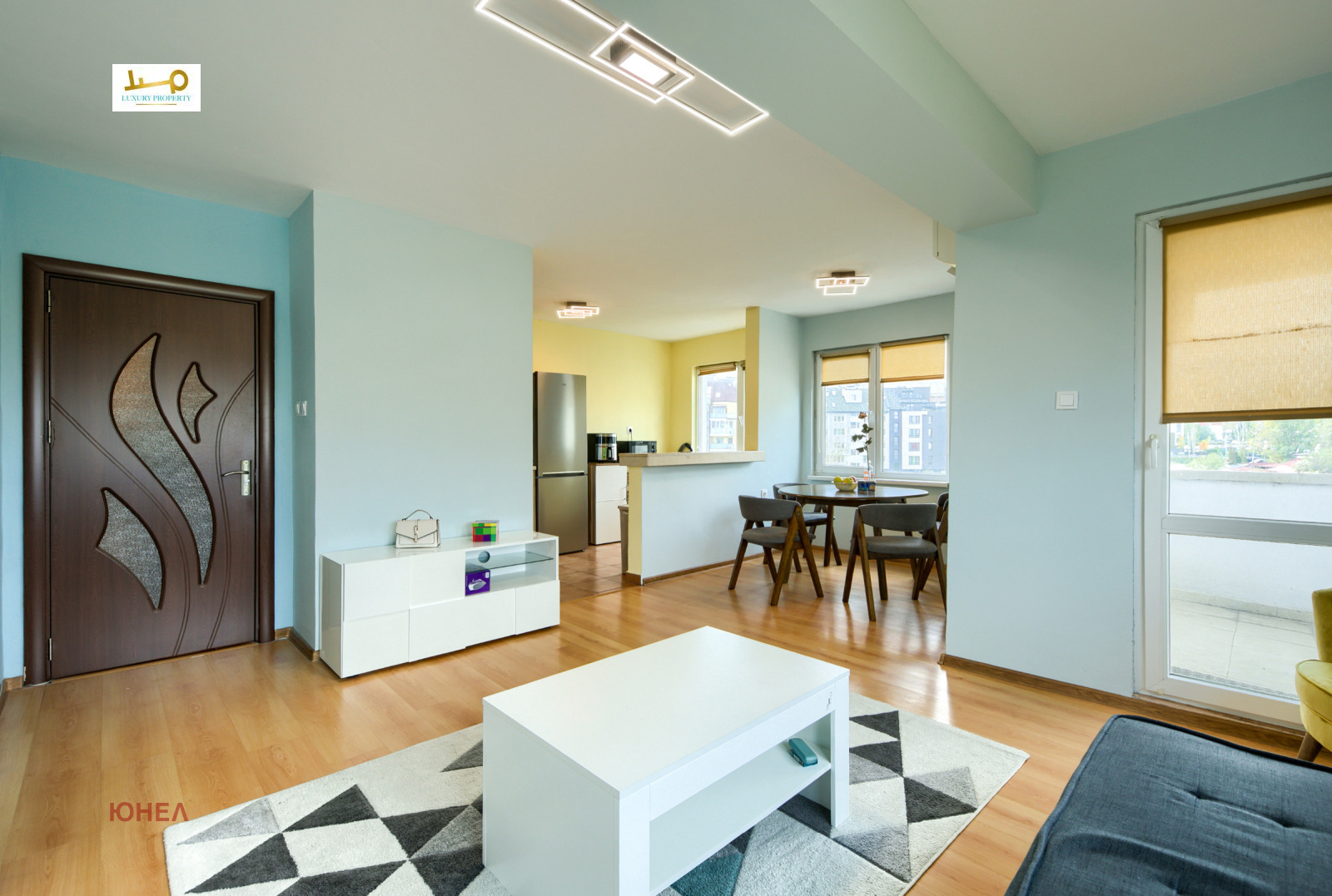 One-Bedroom Apartment in Sofia, open living area with dining table, kitchen bar, laminate floor