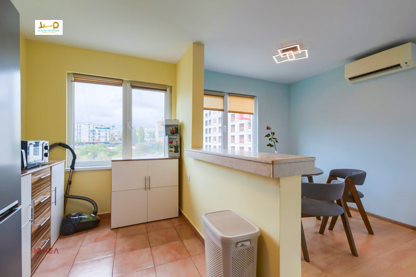 Kitchen area with bar counter, chairs, and city view