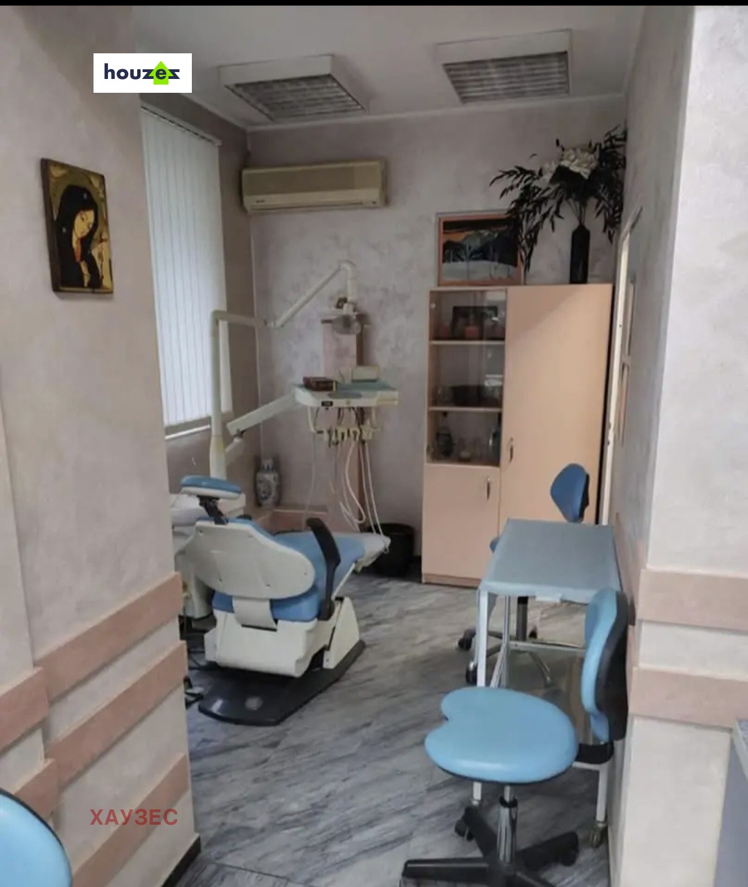 Dental room with patient chair, storage cabinet, and air conditioner